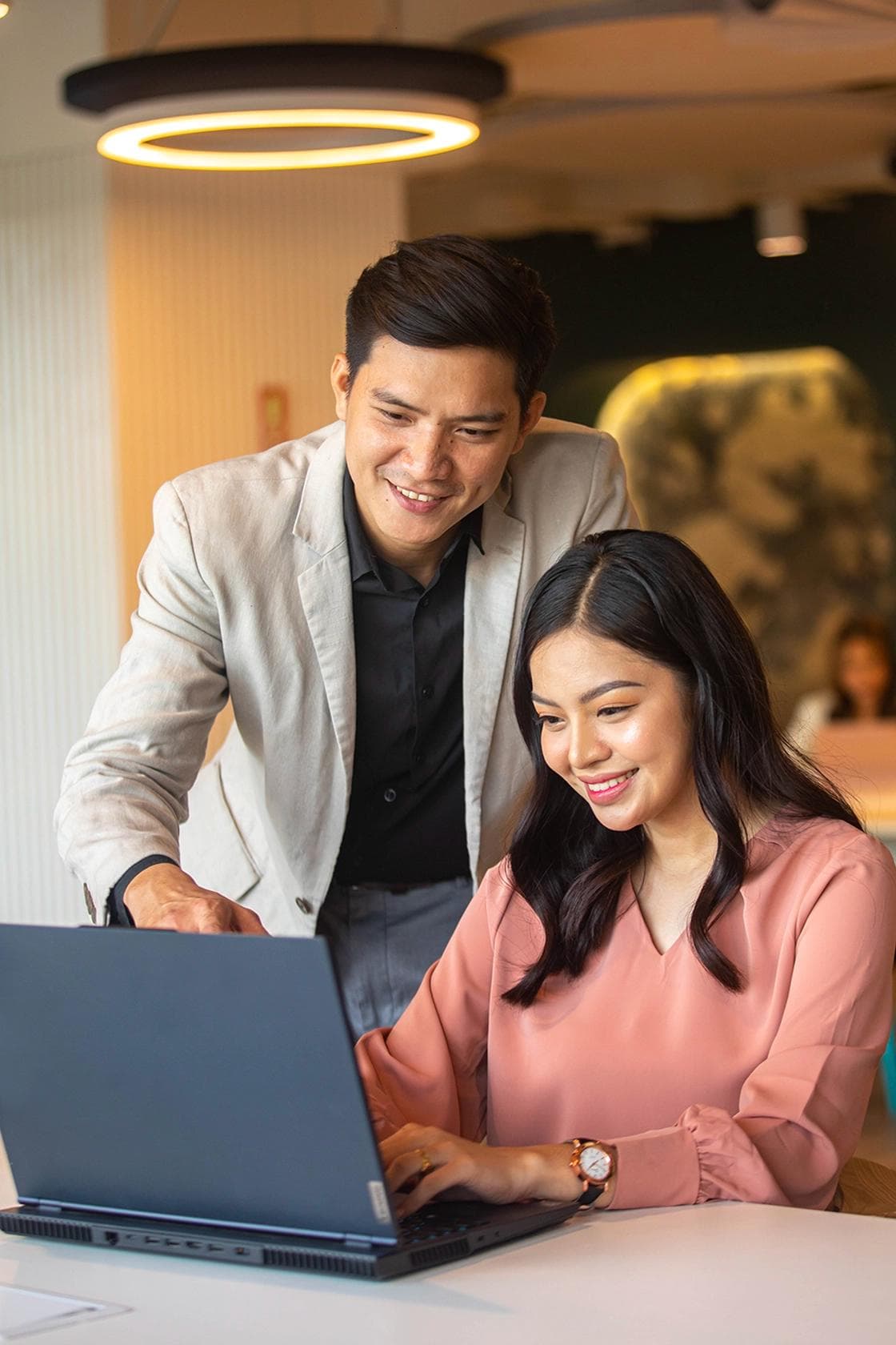 Employee Helping out His Coworker at a KMC Coworking Space