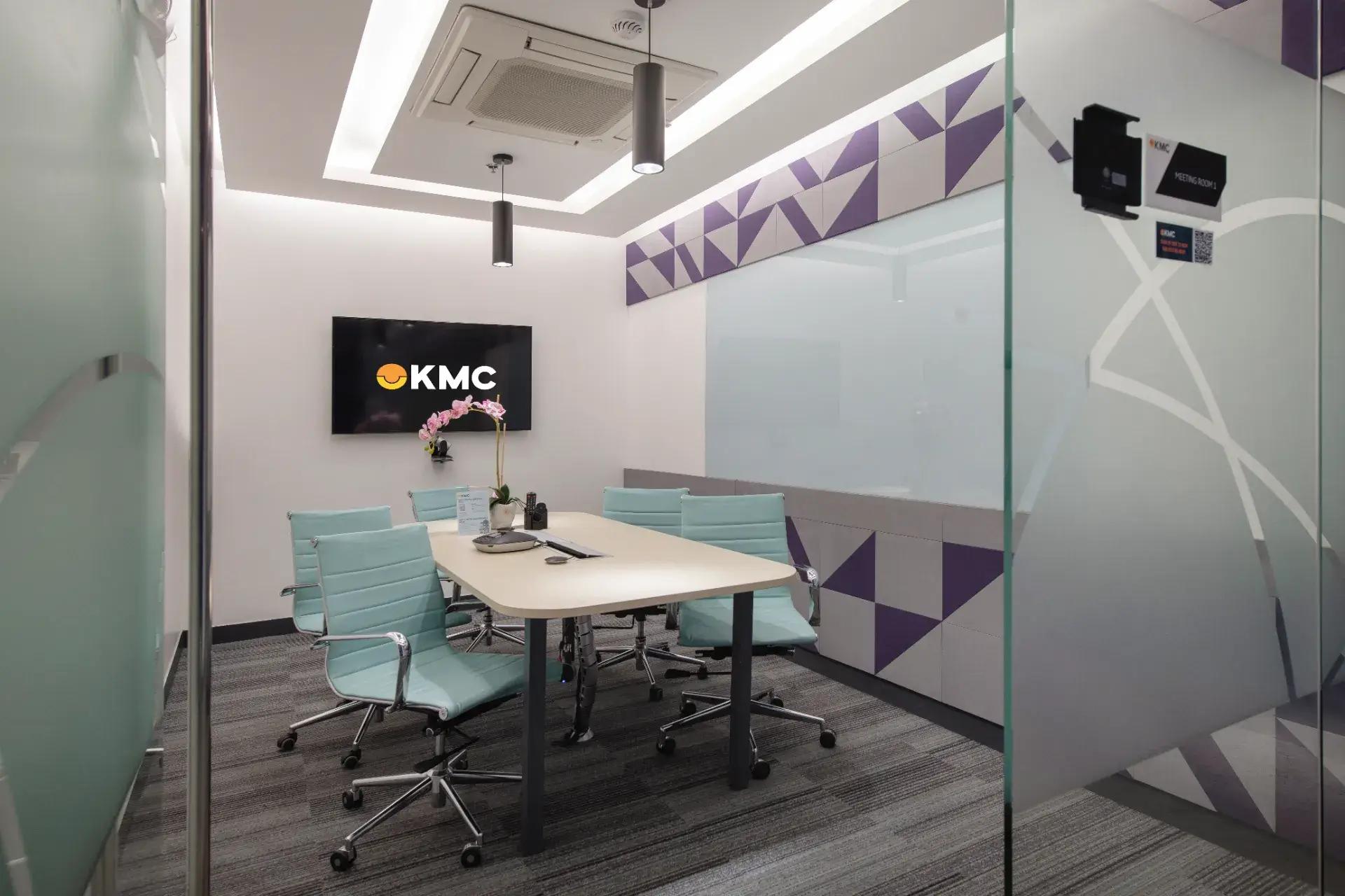 A meeting room with mint chairs, a sleek table, modern lighting, geometric wall design, and a mounted TV for presentations. A meeting room with mint chairs, a sleek table, modern lighting, geometric wall design, and a mounted TV for presentations.