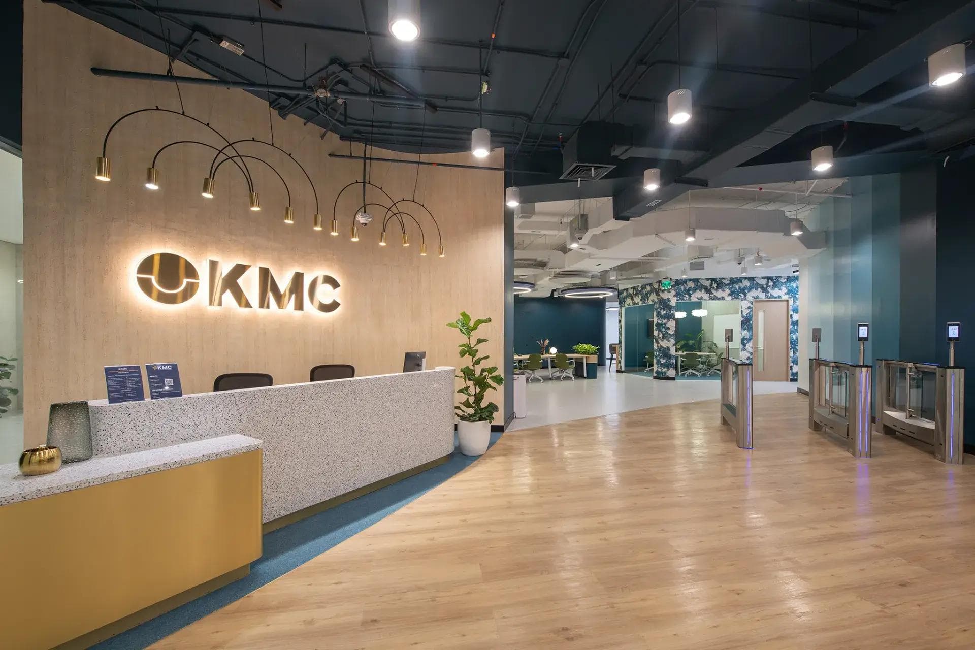 A modern reception featuring sleek pendant lighting, welcoming you to KMC’s private offices in One Ayala, Makati.