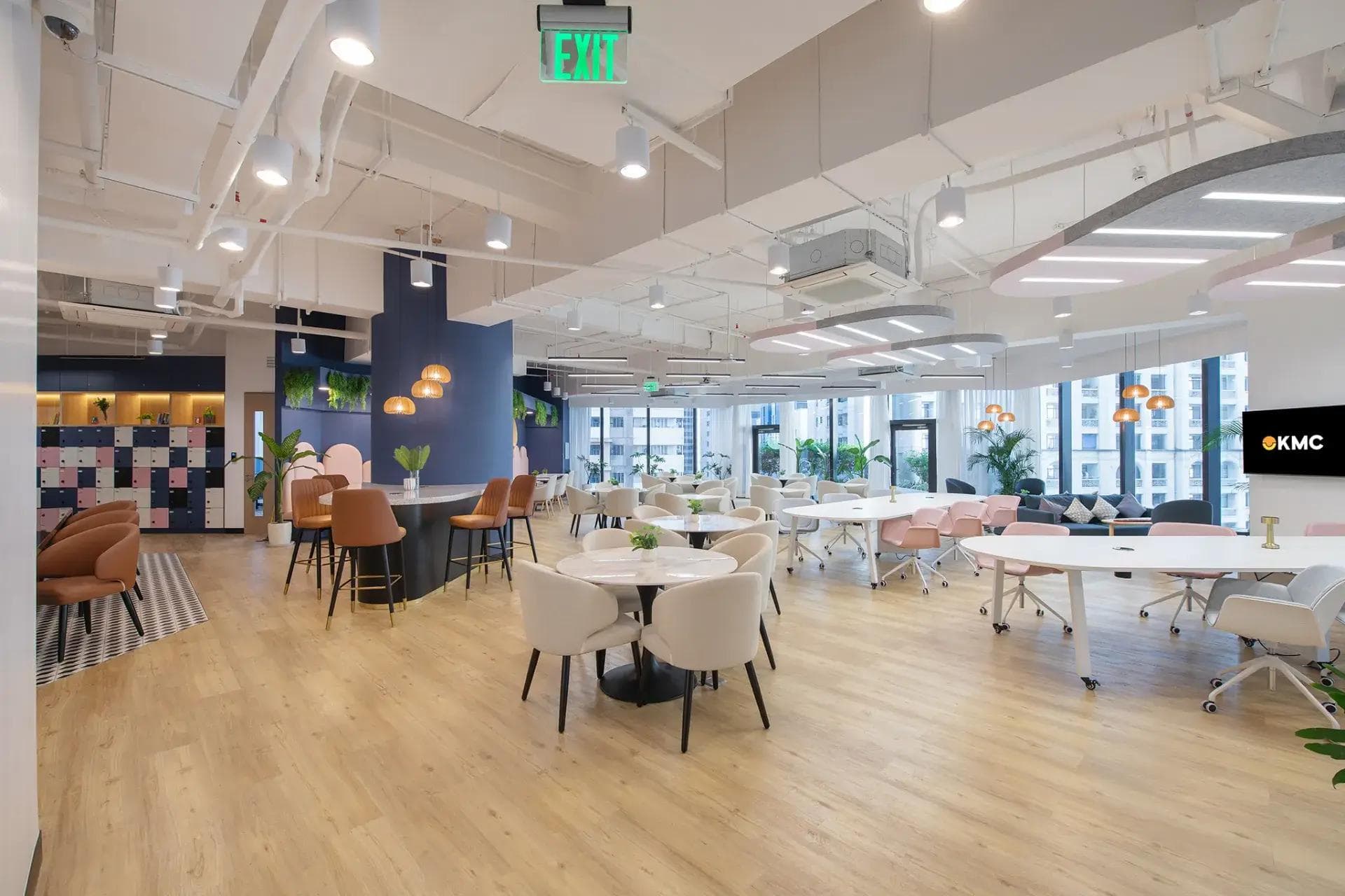 A well-lit office space in Ortigas with modern furnishings, lush decor and floor-to-ceiling windows for a vibrant workspace.