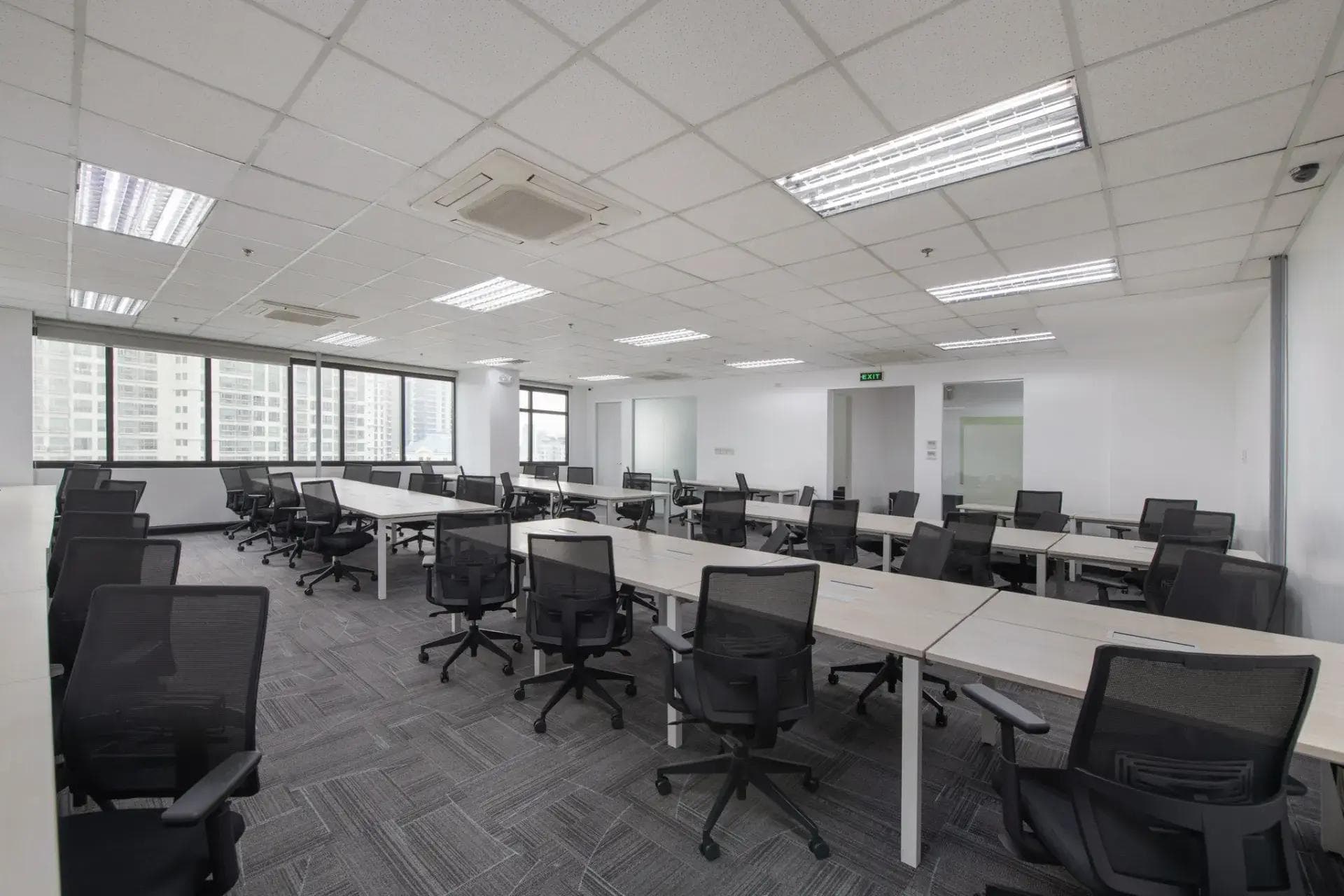 Spacious private office in Picadilly, BGC by KMC, with white walls, ergonomic chairs, and large windows for natural light.