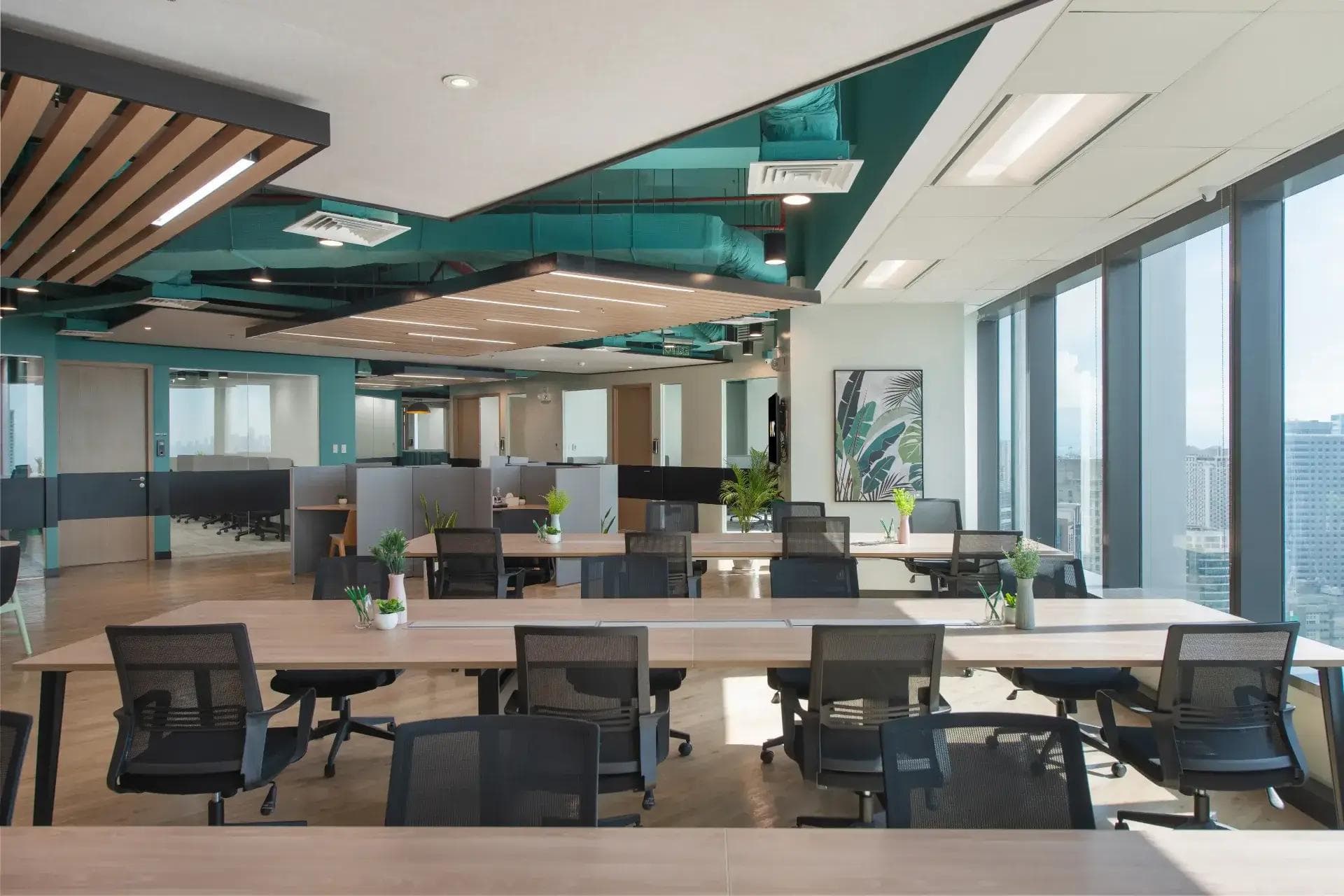 Open-plan coworking office with shared desks, ergonomic chairs, lush accents, floor-to-ceiling windows, city skyline views.
