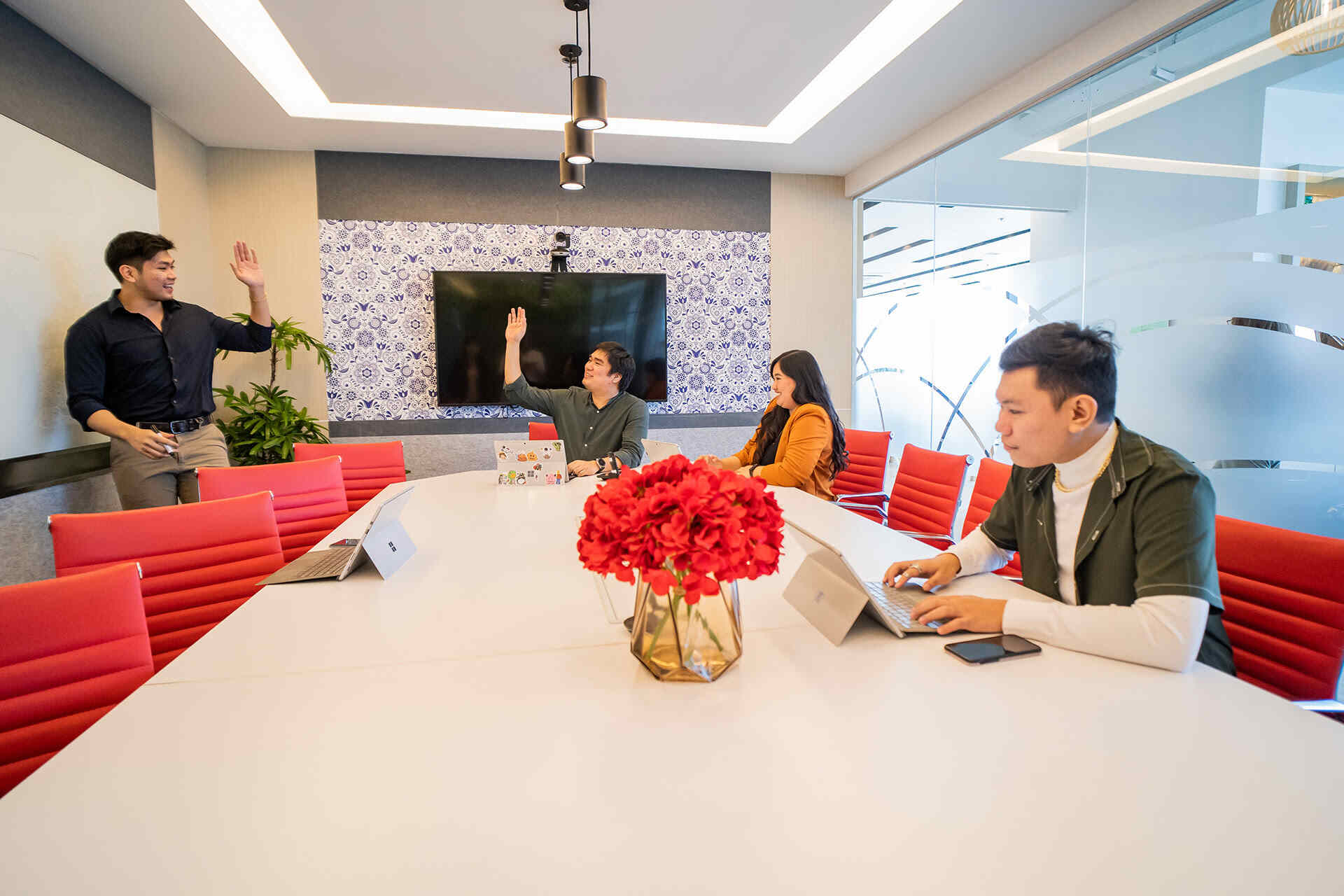Business professionals sitting in a modern conference room, engaged in a discussion on security and data privacy initiatives. Business professionals sitting in a modern conference room, engaged in a discussion on security and data privacy initiatives.