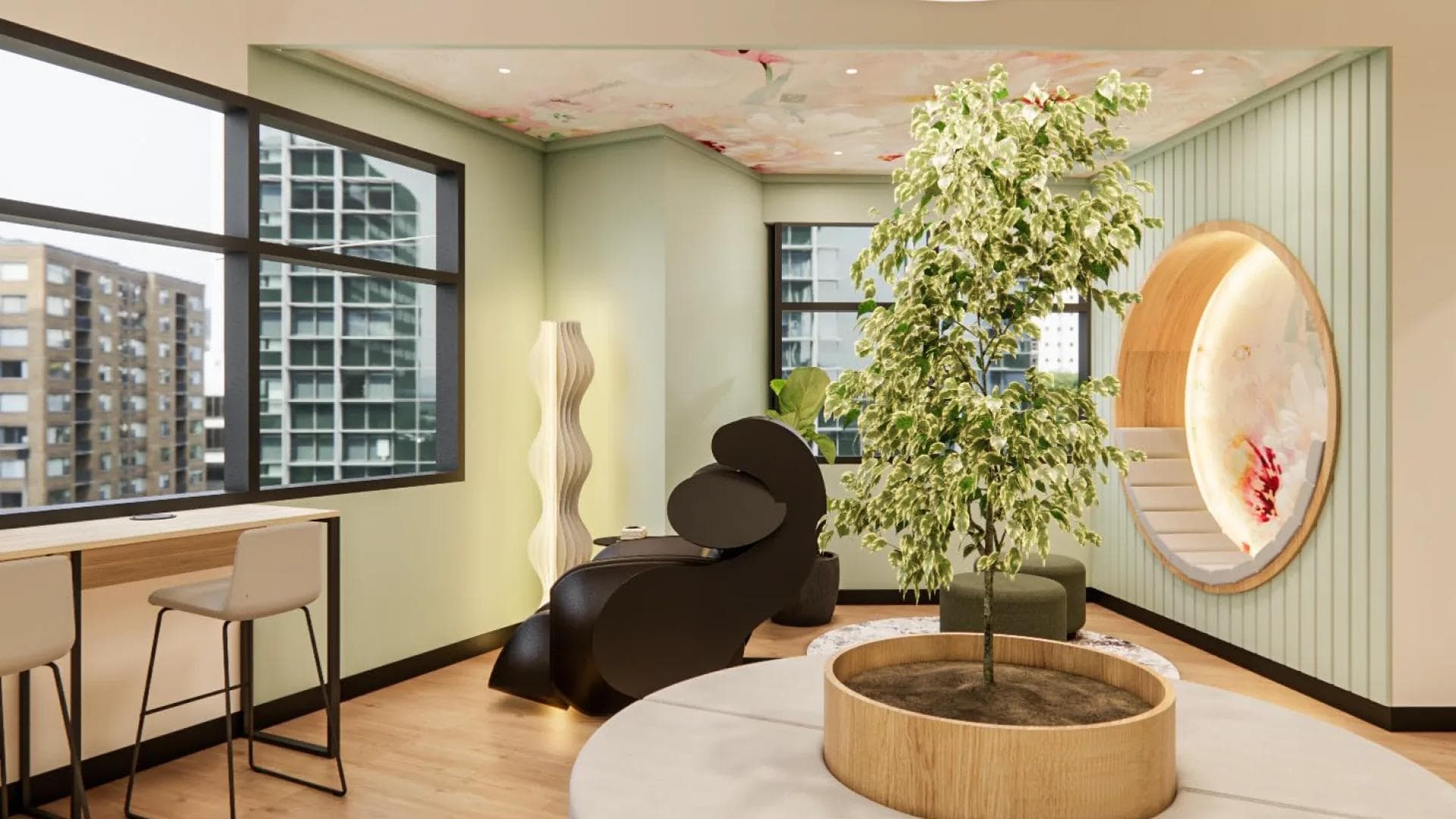 Office relaxation nook in BGC with lounge chairs, pastel walls, circular wall art, and large windows with city views.